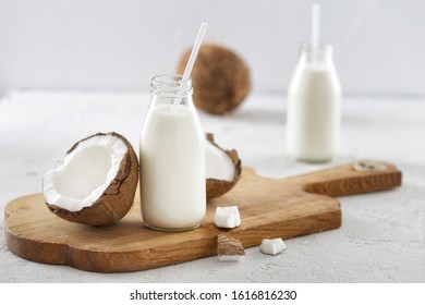 Coconut Kefir In Bottles On White Background. Healthy Eating Concept. Fermented Drinks