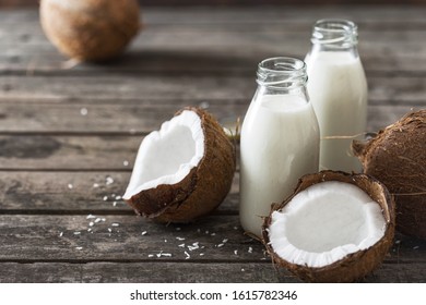 Coconut Kefir In Bottles On Wooden Table. Healthy Eating Concept. Fermented Drinks