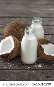 Coconut Kefir In Bottles On Wooden Table. Healthy Eating Concept. Fermented Drinks