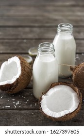 Coconut Kefir In Bottles On Wooden Table. Vegan Non Dairy Healthy Or Fermented Drink. Healthy Eating Concept