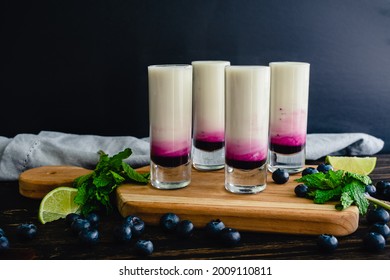 Coconut Lime Mojito Shooters with Blueberry: Coconut mojito shots layered with blueberry syrup - Powered by Shutterstock