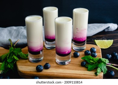 Coconut Lime Mojito Shooters with Blueberry: Coconut mojito shots layered with blueberry syrup - Powered by Shutterstock