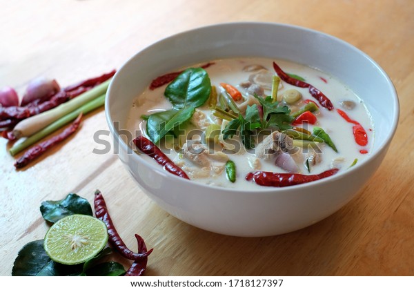 coconut milk soup\
with chicken ( Tom Kha Gai ) on wooden table top view, Thai local\
food,Chicken Coconut\
Soup\
