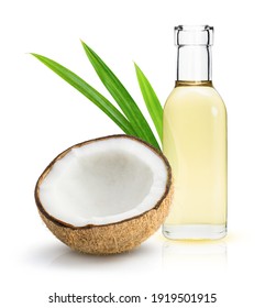 Coconut oil in glass bottle and coconut fruit with green leaves isolated on white background. - Shutterstock ID 1919501915