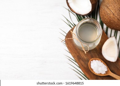 Coconut Oil On White Wooden Table, Flat Lay. Space For Text