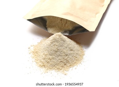 Coconut Protein Powder Pile And Paper Bag Isolated On White Background