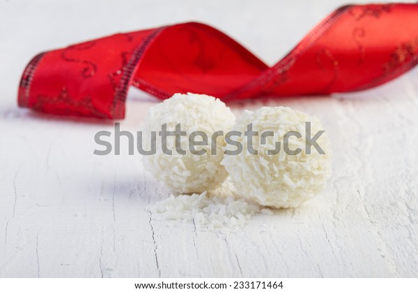 Coconut snowball\
truffles on white background. Arrangement of coconut cookies on\
wooden elegant\
background.