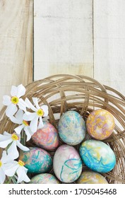 Coconut Sticks Plate With Colorful Easter Eggs And  Poets Narcissus Flowers On Wooden Table