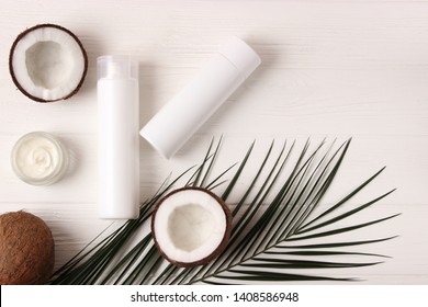 Coconut, Tropical Leaf And Care Products On A Colored Background Top View. Cosmetics With Coconut Extract For Hair, Body, Face. Skin Care, Skin Hydration. Flatlay
