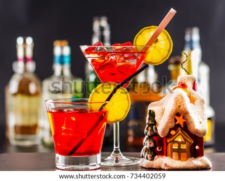 Coctail and beautiful Christmas house, candle, bottle background, xmas set, snow