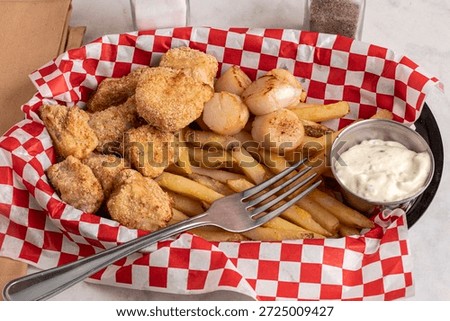cod bites served with pan sheared scallops and french fries