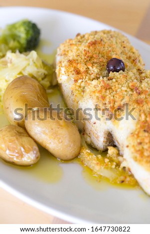 Cod with bread also know ed as "Bacalhau com Broa" a traditional Portuguese plate.