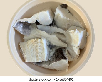 Cod fish being rehydrated to remove the excess salt before cooking
