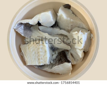 Cod fish being rehydrated to remove the excess salt before cooking