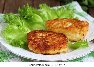 Cod Fish Cakes Served With A Salad.