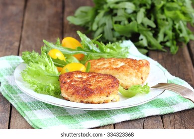 Cod Fish Cakes Served With A Salad.