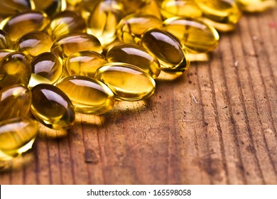 Cod Liver Oil Omega 3 Gel Capsules Isolated On Wooden Background 