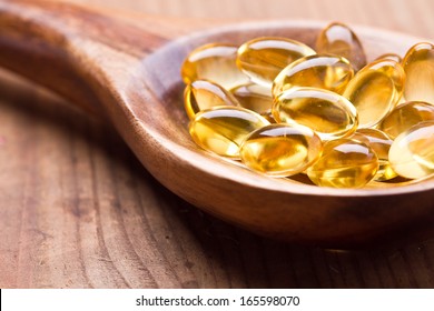 Cod Liver Oil Omega 3 Gel Capsules Isolated On Wooden Background 