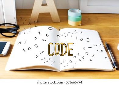 Code concept with notebook on wooden desk 
