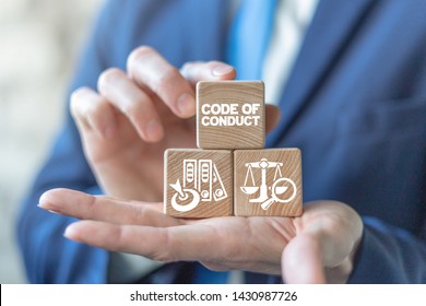Code Of Conduct Business Concept On Wooden Blocks In Businessman Hands. Ethics And Respect In Working Collective.
