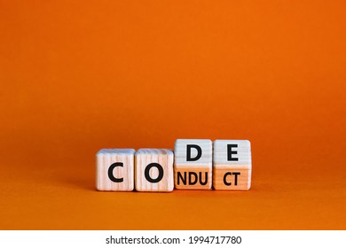Code of conduct symbol. Turned the wooden cube and changed the word code to conduct. Beautiful orange background. Business and code of conduct concept. Copy space. - Shutterstock ID 1994717780