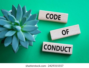 Code of conduct symbol. Wooden blocks with words Code of conduct. Beautiful green background with succulent plant. Business and Code of conduct concept. Copy space.