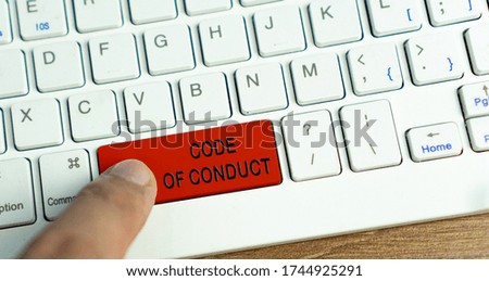 CODE OF CONDUCT words on red button keyboard