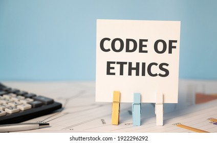 CODE OF ETHICS On A Sticker Beside A Calculator And A Pen. Finances And Business Concept.