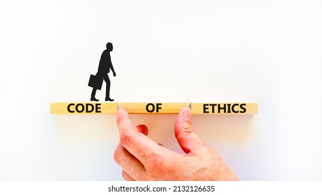 Code of ethics symbol. Concept words Code of ethics on wooden blocks on a beautiful white table white background. Businessman hand. Business and code of ethics concept. Copy space. - Shutterstock ID 2132126635