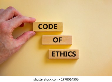 Code Of Ethics Symbol. Wooden Blocks With Words 'Code Of Ethics'. Beautiful White Background. Businessman Hand. Copy Space. Motivational, Business And Code Of Ethics Concept.