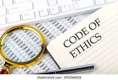 CODE OF ETHICS Text On The Notebook With Chart, Magnifier,keyboard And Pen , Finance And Investment Concept