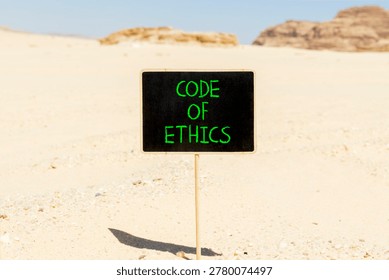 Code of ethics words symbol. Concept words Code of ethics on beautiful blackboard. Beautiful Sinai desert sand background. Business Code of ethics concept. Copy space.