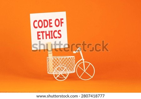 Code of ethics words symbol. Concept words Code of ethics on beautiful white paper on wooden clothespin. Beautiful orange background. White bicycle. Business Code of ethics concept. Copy space.