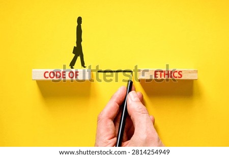Code of ethics words symbol. Concept words Code of ethics on beautiful wooden blocks. Beautiful yellow background. Businessman hand. Business Code of ethics concept. Copy space.