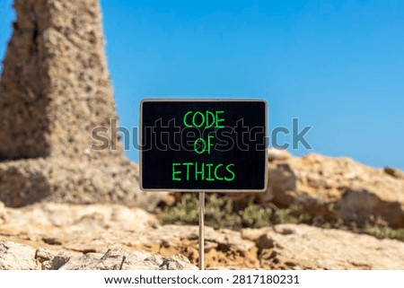 Code of ethics words symbol. Concept words Code of ethics on beautiful black blackboard. Beautiful stone and blue sky background. Business Code of ethics concept. Copy space.