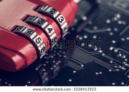 Code numbers on combination pad lock on computer circuit board with solder, digital cyber safety or security encryption concept, technology to encode online information or data protection.