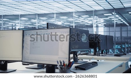 Code running on computer screens in empty data center workspace, used for troubleshooting rackmounts. Close up of script working on desktop PC monitors upgrading mainframes systems in server room