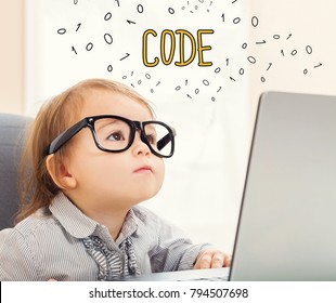 Code text with toddler girl using her laptop