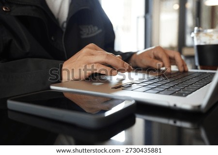 Code-up of a hand playing on a computer.
