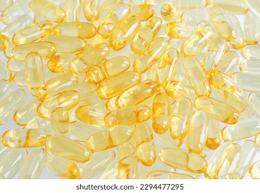 Cod-liver oil (vitamin D, E, A, cosmetic serum) supplement softgel capsules. Close-up, selective focus