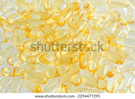 Cod-liver oil (vitamin D, E, A, cosmetic serum) supplement softgel capsules. Close-up, selective focus