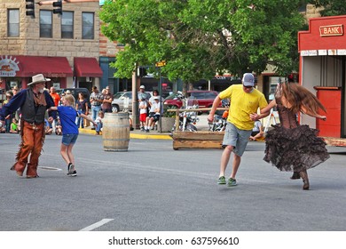 CODY, WYOMING - July 3, 2016 - Tourists Dancing With Old Western Shootout Performers