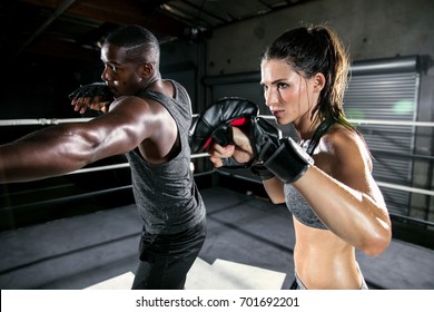 Coed boxing gym training class focused on high intensity martial arts training and aerobics - Powered by Shutterstock