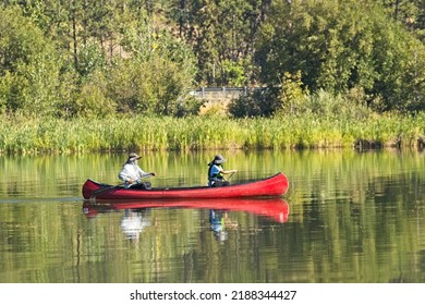 Coeur D'Alene, Idaho  USA - 08-08-2022: An Editorial Photo Of A Mature Couple Paddling The Canoe On Coeur D'Alene Lake In North Idaho.