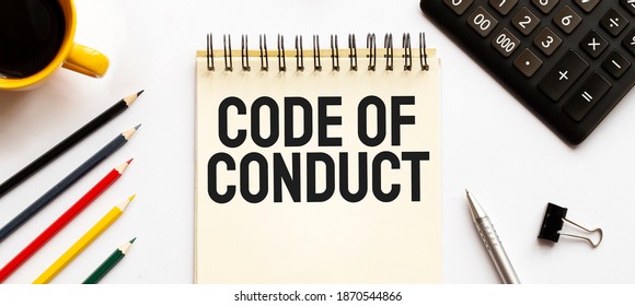 Cofee cup, calculator,notepad,pen and pencils on the white background. Business concept. Text CODE OF CONDUCT - Shutterstock ID 1870544866