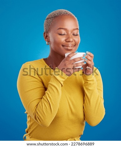 Coffee, aroma and a black woman on a blue background in studio smelling the scent for her mug. Relax, drink and easy with an attractive young female enjoying a fresh cup of caffeine during a break