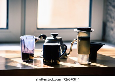 Coffee background with airpress devices, ground coffee, teapot, and mug. All instruments to brew alternative coffee.  - Shutterstock ID 726690844