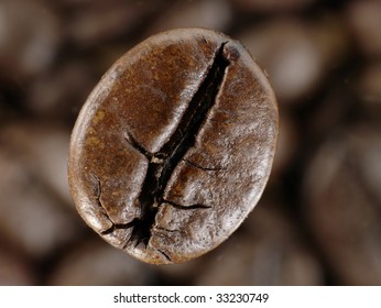 Coffee bean in deep shadows over unfocused grains background