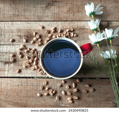 Coffee, bean and flower on woodbackground