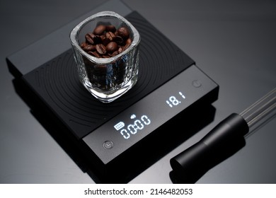 Coffee bean inside the espresso glass scale shot on a digital coffee scale preparing for coffee brewing